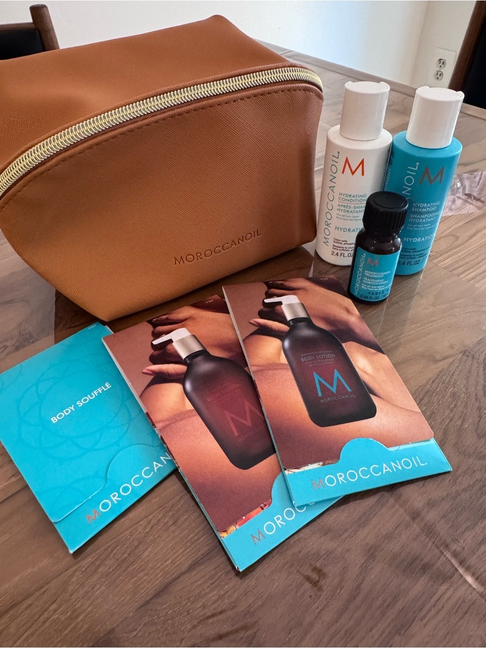 Moroccanoil Tan Travel Pouch with Blue and White Product Samples